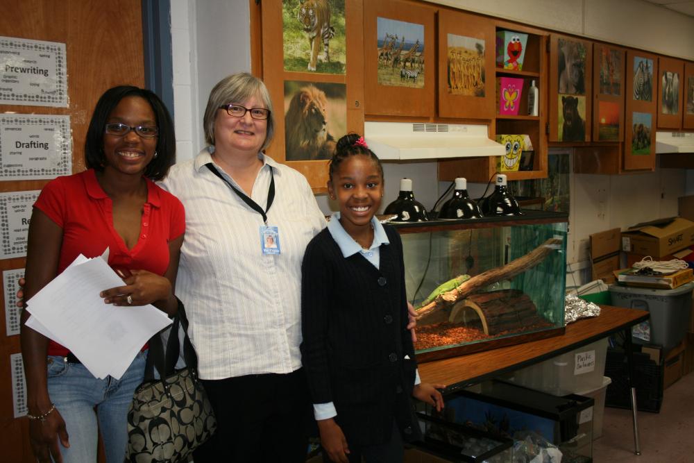 A Greater Heights Academy teacher with students